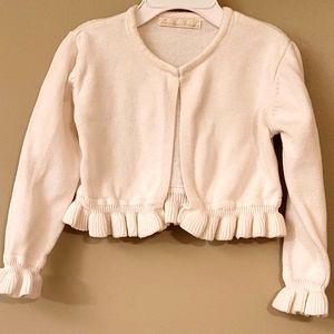 Adorable ivory sweater with bottom and cuff frills